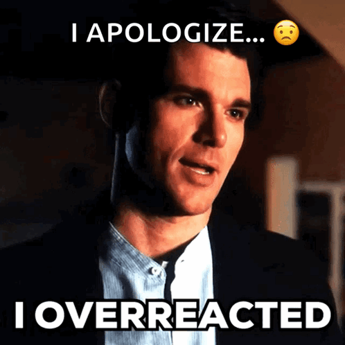 Man In Suit With I Overreacted Below Him GIF