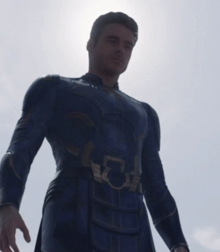 A Man In A Superhero Costume Has A Light Coming Out Of His Eye GIF
