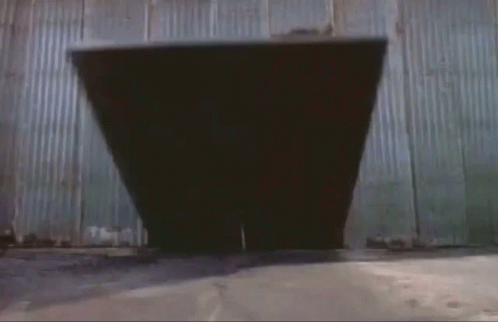 A Man In A Superhero Costume Is Jumping Through A Doorway GIF