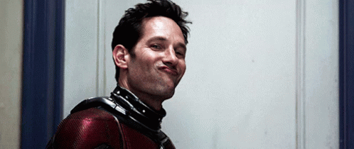 a man in a superhero costume is making a face .