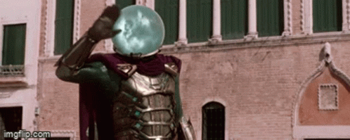 A Man In A Superhero Costume Is Standing In Front Of A Building With A Sphere On His Head . GIF