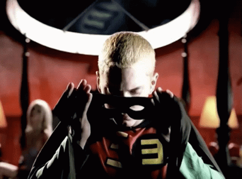 A Man In A Superhero Costume With The Letter E On His Chest GIF