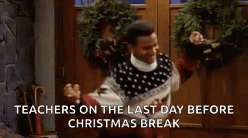 A Man In A Sweater Is Dancing In Front Of A Door With A Christmas Wreath . GIF