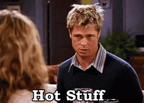 A Man In A Sweater Is Talking To A Woman And The Words Hot Stuff Are Next To Him GIF