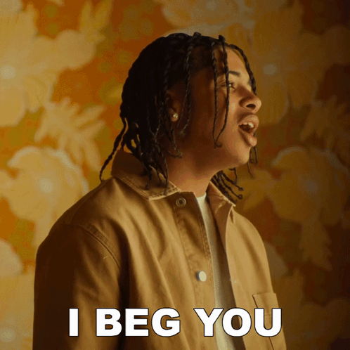 A Man In A Tan Jacket Says I Beg You In White Letters GIF