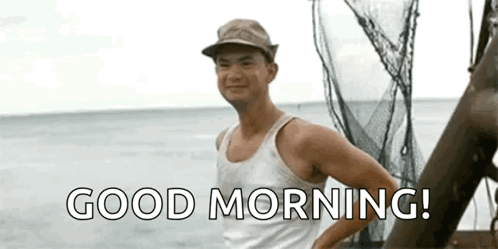 A Man In A Tank Top And Hat Is Standing On A Boat In The Ocean And Saying `` Good Morning '' . GIF