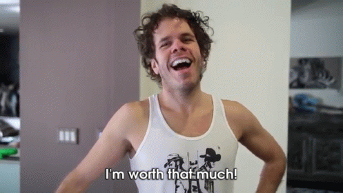 A Man In A Tank Top Is Laughing And Says I 'M Worth That Much GIF