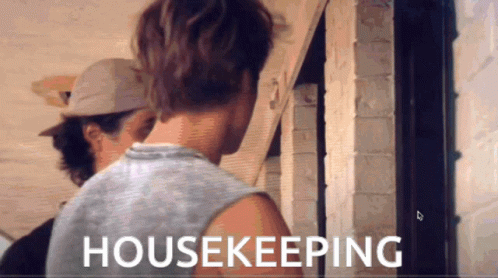 A Man In A Tank Top Is Standing Next To Another Man In A Hat And The Words Housekeeping Are Displayed On The Screen GIF