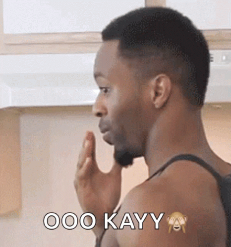 A Man In A Tank Top Says Ooo Kayy With A Monkey On His Arm GIF