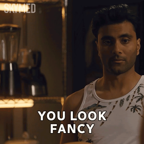 A Man In A Tank Top Says " You Look Fancy " In Front Of A Blender GIF