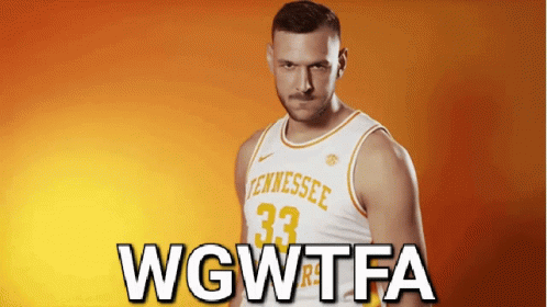 A Man In A Tennessee Jersey Stands In Front Of A Orange Background GIF