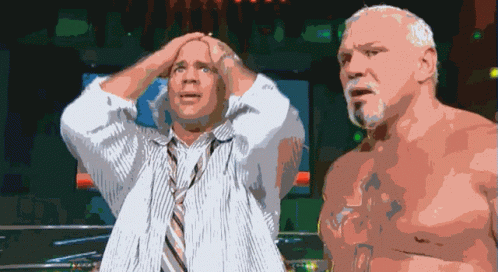 A Man In A Tie Holds His Head While Another Man Looks On GIF