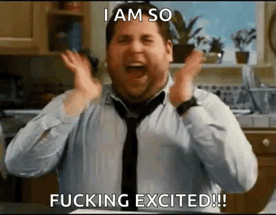 A Man In A Tie Is Making A Funny Face In A Kitchen . GIF