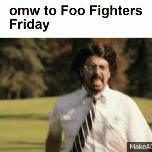A Man In A Tie Is Running In A Field With The Words Omw To Foo Fighters Friday GIF