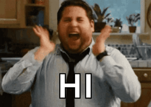 A Man In A Tie Is Screaming With His Hands In The Air And Says Hi GIF