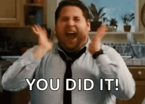 A Man In A Tie Is Screaming With His Hands In The Air . GIF