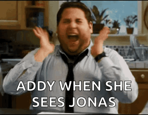 A Man In A Tie Is Screaming With The Words " Addy When She Sees Jonas " Above Him GIF