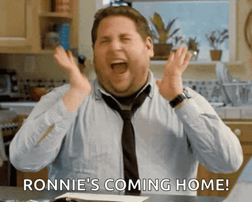 A Man In A Tie Is Screaming With The Words Ronnie 'S Coming Home Below Him GIF