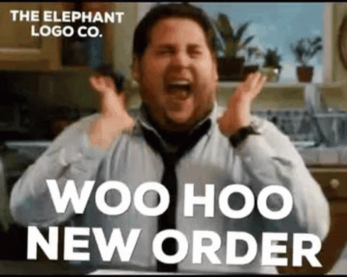 A Man In A Tie Is Sitting In A Kitchen With His Hands In The Air And Screaming . GIF