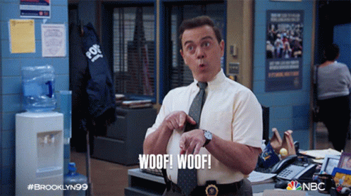 A Man In A Tie Says Woof Woof In An Office GIF