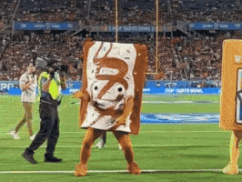 A Man In A Toaster Pastries Costume Is Walking On A Football Field GIF