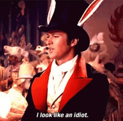 A Man In A Top Hat And Bunny Ears Is Saying I Look Like An Idiot GIF