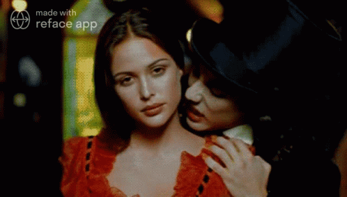 A Man In A Top Hat Is Holding A Woman In A Red Dress GIF