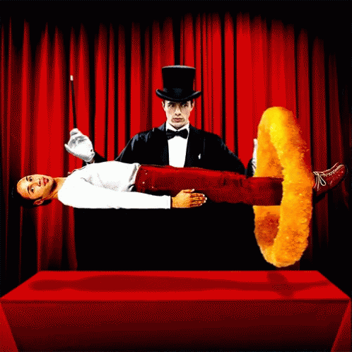 A Man In A Top Hat Is Performing A Trick With A Chicken Ring GIF