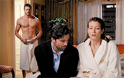 Man In Towel Behind Woman And Shirtless Man GIF