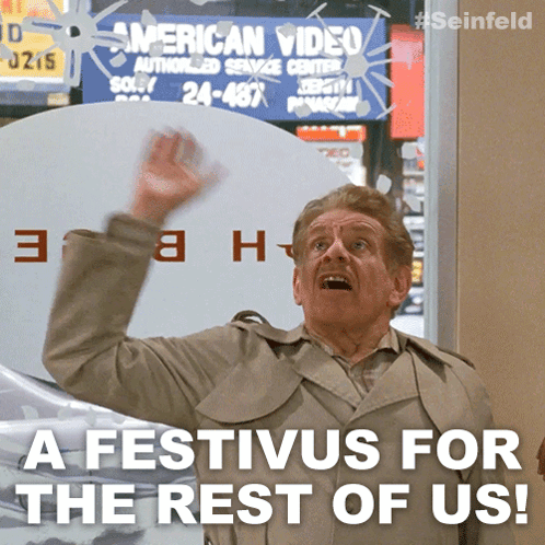 A Man In A Trench Coat Is Standing In Front Of A Sign That Says American Video GIF