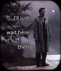 A Man In A Trench Coat Is Standing On A Sidewalk With The Words I 'Ll Just Wait Here Then GIF