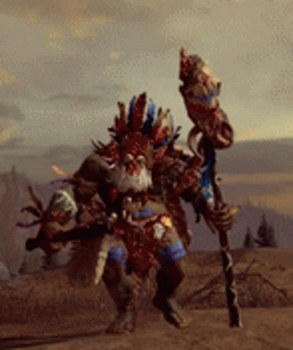 A Man In A Tribal Costume Is Holding A Stick GIF