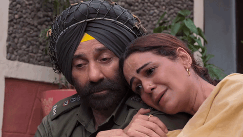 A Man In A Turban Is Hugging A Woman GIF
