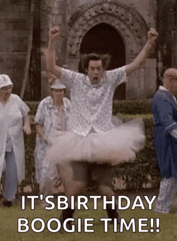 A Man In A Tutu Is Jumping In The Air While A Group Of People Are Standing Behind Him . GIF