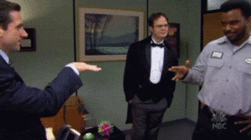 A Man In A Tuxedo And A Man In A Nbc Shirt GIF