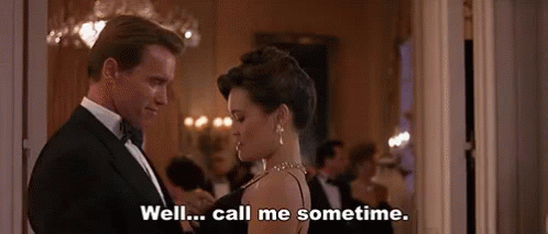 A Man In A Tuxedo And A Woman In A Black Dress Are Dancing In A Room . GIF