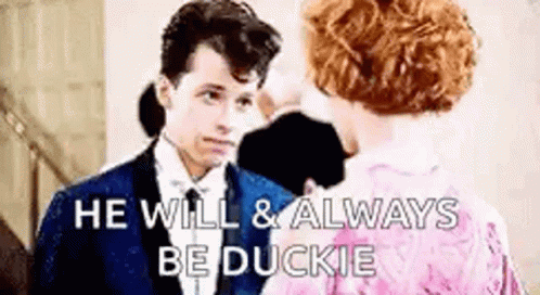 Man And Woman In Formal Attire Talking GIF