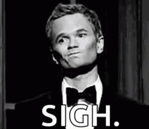 A Man In A Tuxedo And Bow Tie Is Making A Funny Face And Says Sigh . GIF