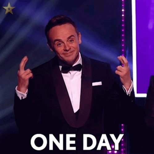 A Man In A Tuxedo And Bow Tie Is Making A Gesture With His Hands And The Words One Day Are Behind Him . GIF