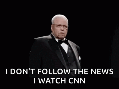 A Man In A Tuxedo And Bow Tie Is Saying I Do N't Follow The News GIF