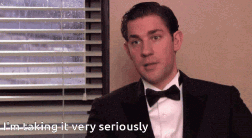 A Man In A Tuxedo And Bow Tie Is Taking It Very Seriously GIF