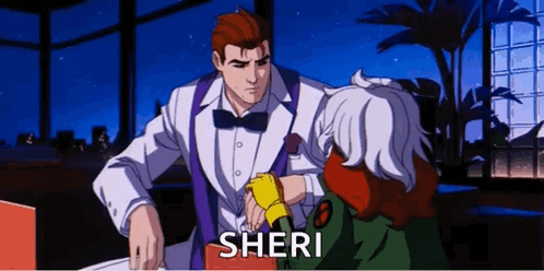 A Man In A Tuxedo And Bow Tie Is Talking To A Woman In A Green Jacket Named Sheri . GIF