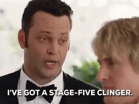 A Man In A Tuxedo And Bow Tie Is Talking To A Woman In A Suit . GIF