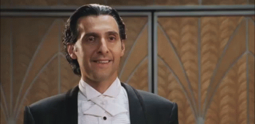 A Man In A Tuxedo And Bow Tie Says " I Am ... " GIF
