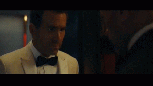 A Man In A Tuxedo And Bow Tie Says " You Love Me " GIF
