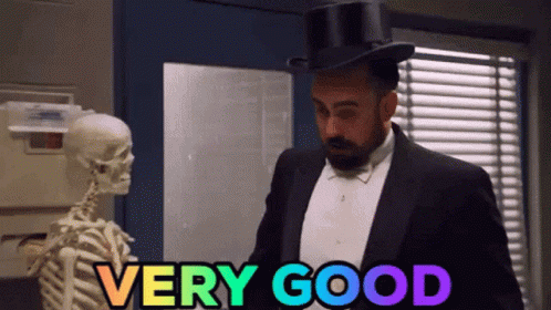 Man In Tuxedo And Top Hat Next To Skeleton Says Very Good GIF