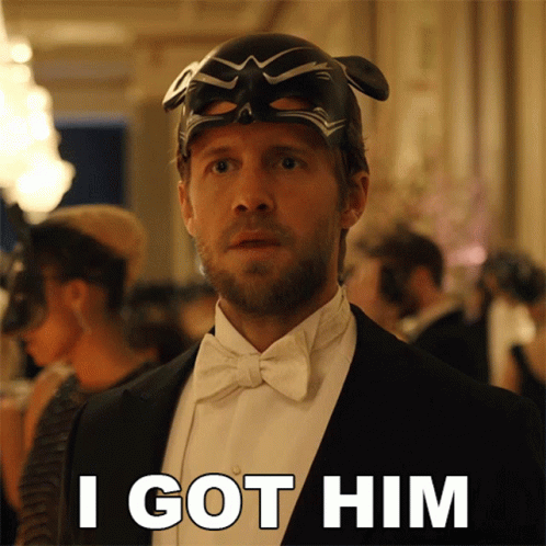 a man in a tuxedo has a mask on his head and says i got him