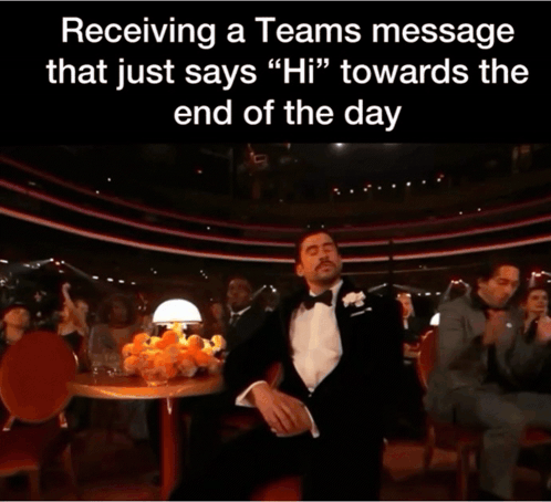 A Man In A Tuxedo Holds His Hand To His Face In Front Of A Crowd GIF