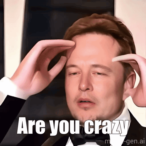 A Man In A Tuxedo Holds His Hands To His Forehead With The Words Are You Crazy Written Below Him GIF