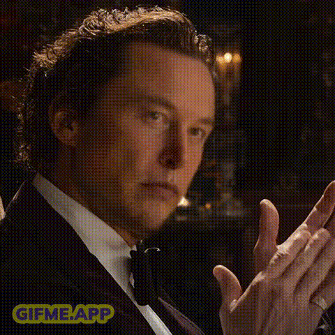 A Man In A Tuxedo Is Clapping His Hands And Wearing A Ring . GIF